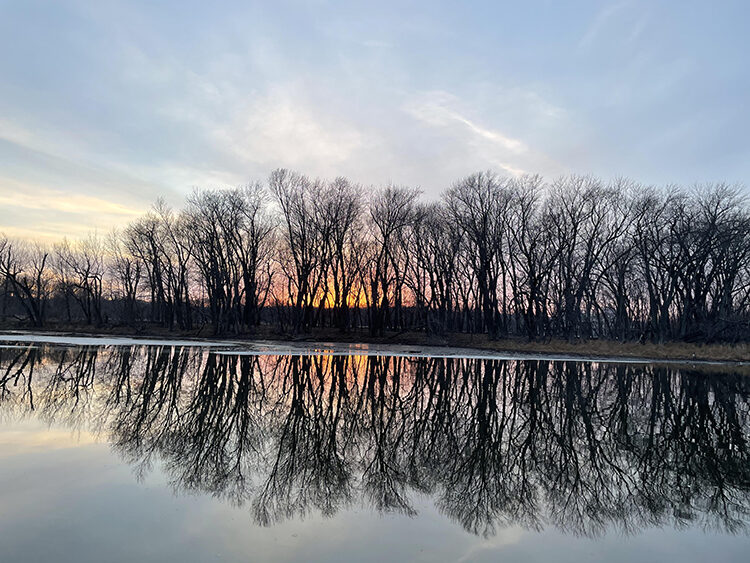 The setting sun reflects in the water of the Mississippi River near Newport, MN.